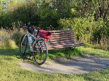 a bicycle is parked on a bench