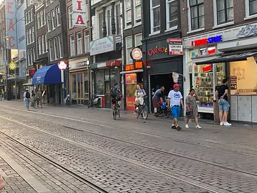 people riding bikes on a brick road