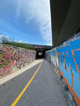 a road with graffiti on the side