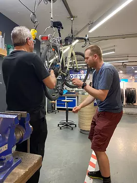 men working on a bicycle