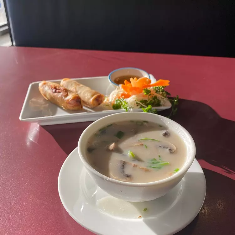 a bowl of soup next to a plate of food