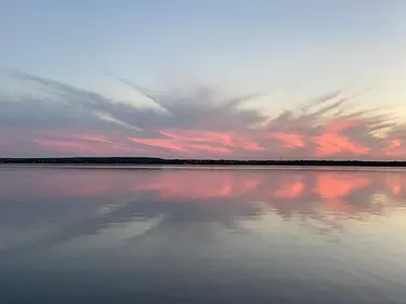 a body of water with a sunset