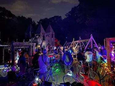 a group of people with bicycles at night