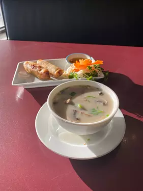 a bowl of soup next to a plate of food