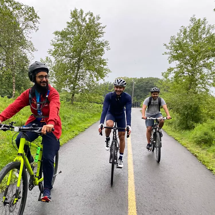 a group of people riding bikes on a road