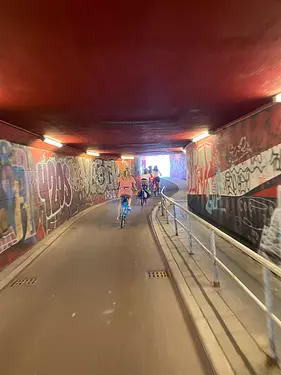 a group of people riding bikes in a tunnel