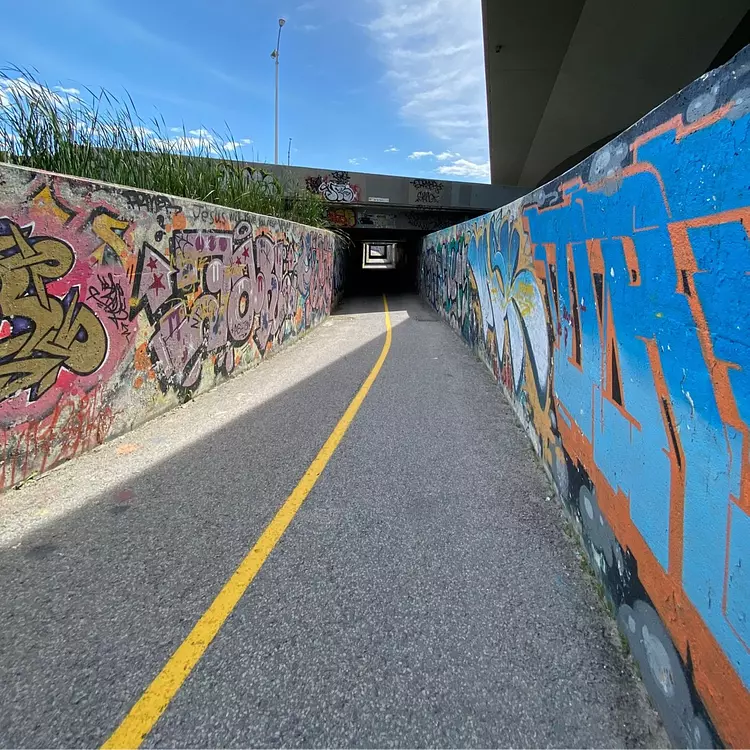 a road with graffiti on the side