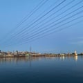 a body of water with power lines above it