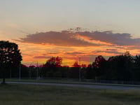a sunset over a field