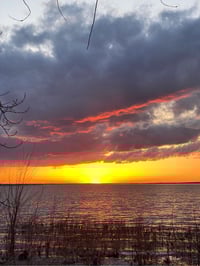 a sunset over a body of water