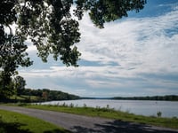 a road next to a body of water