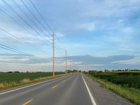 a road with power lines on the side
