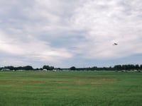 a plane flying over a field