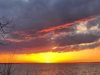 a sunset over a body of water