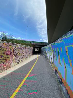 a road with graffiti on the side