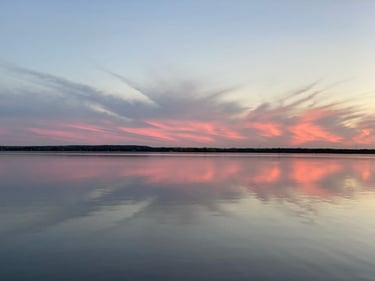a body of water with a sunset