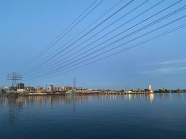 a body of water with power lines above it
