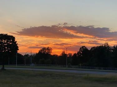 a sunset over a field