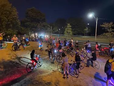 a group of people with bicycles at night