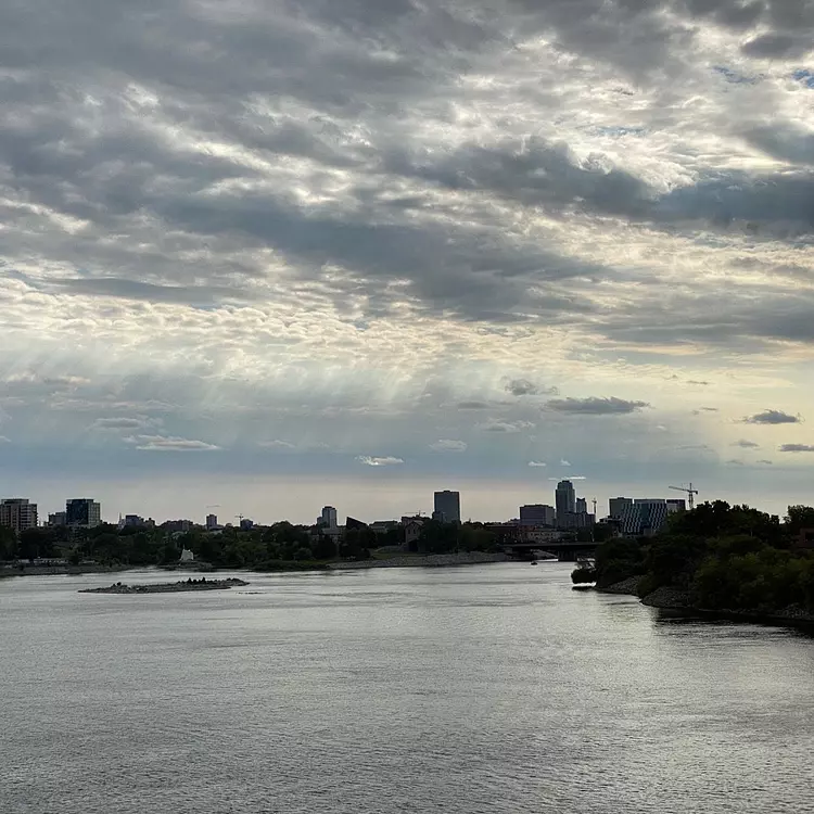 a body of water with a city in the background