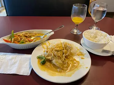 a table with plates of food and glasses of juice