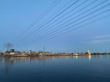 a body of water with power lines above it