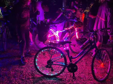 a group of people standing around bicycles