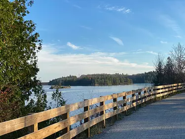 a wooden railing overlooking a body of water