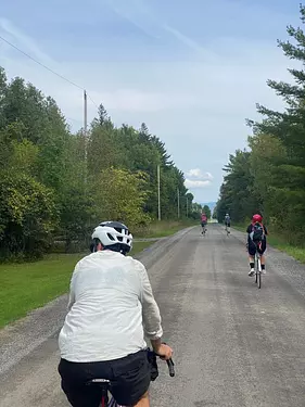 a group of friends riding bikes on a road