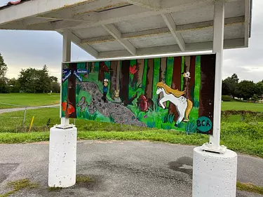 a sign with a picture of a horse and a dog on it