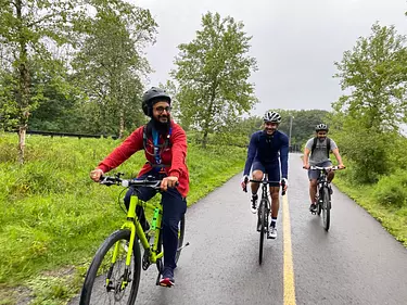 a group of people riding bikes on a road