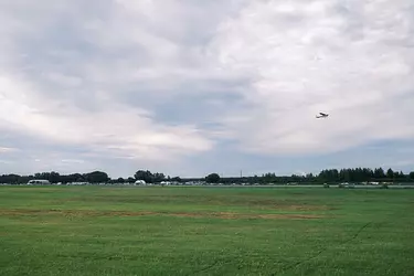 a plane flying over a field