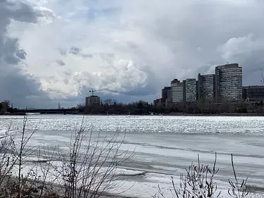 a frozen lake with buildings in the background