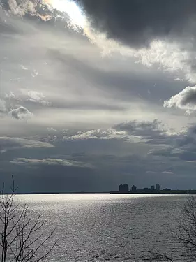 a body of water with a city in the distance