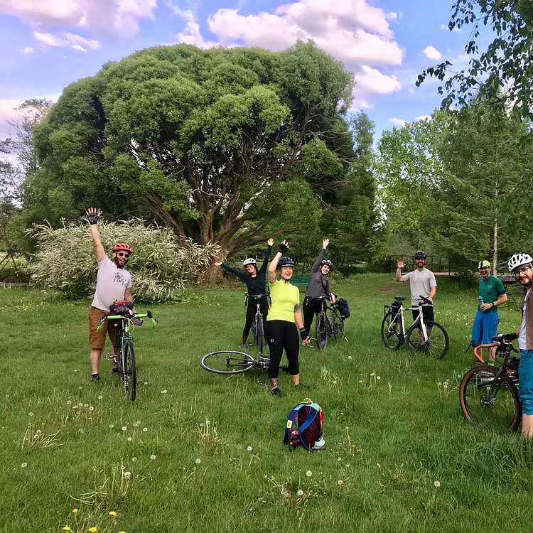 a group of people on bicycles in a grassy field