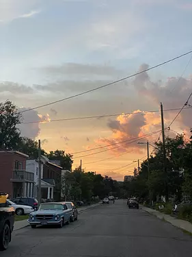 a street with cars and houses on the side