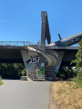 a concrete bridge with graffiti