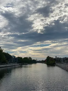 a body of water with buildings and trees around it