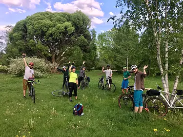 a group of people on bicycles in a grassy field