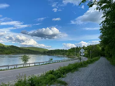 a road next to a body of water