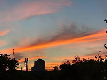 a silhouette of a building and trees