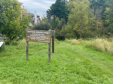 a sign in a grassy area