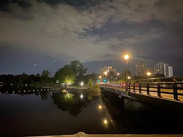 a body of water with a city in the background