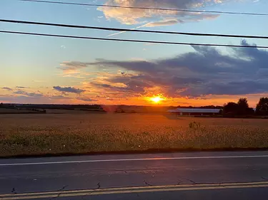 a sunset over a field